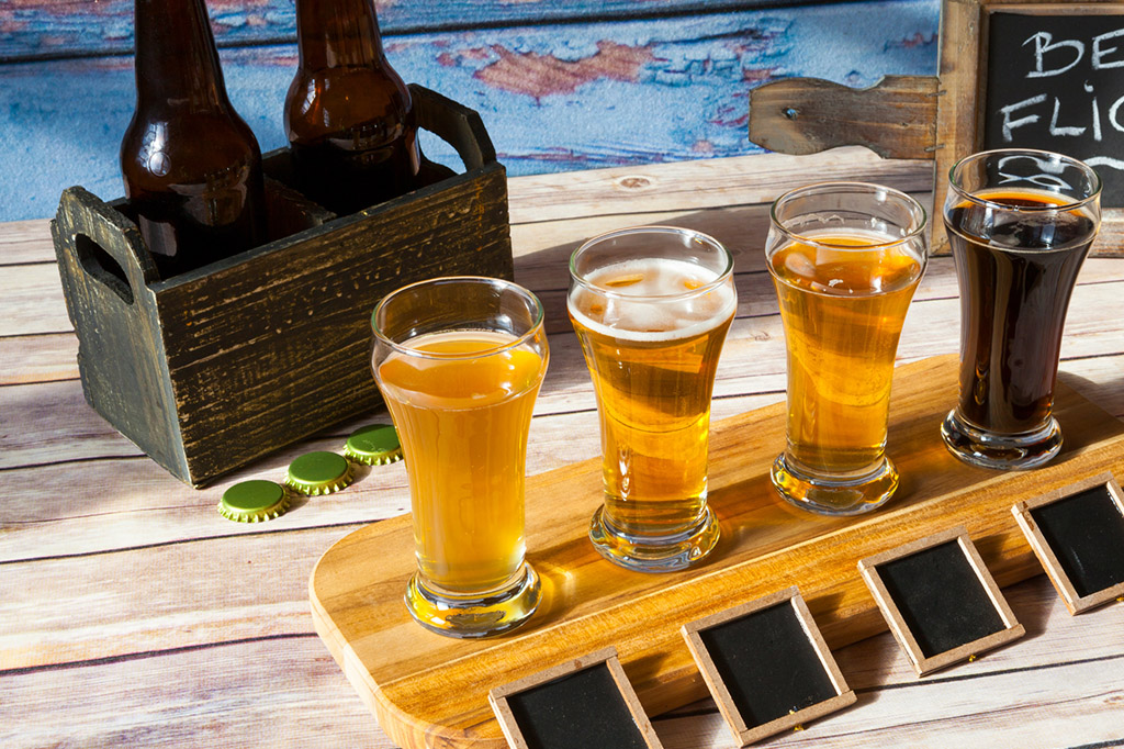 Four specialty beers lined up in a flight