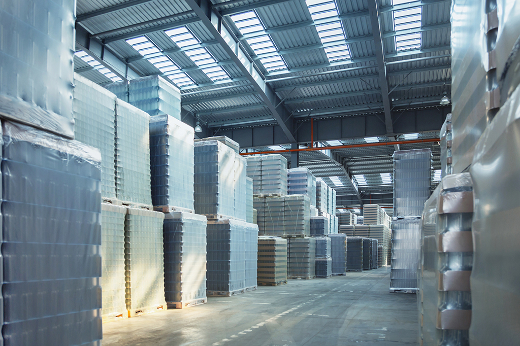 Warehouse filled with glass bottles on wooden pallets 