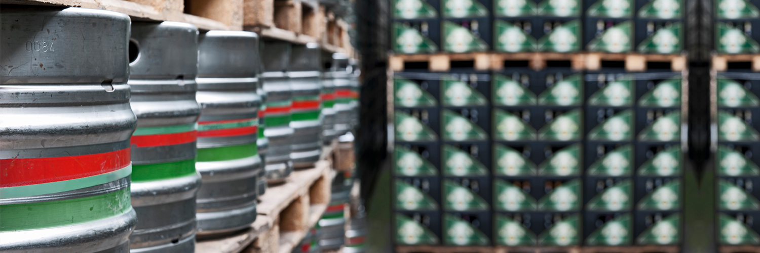 Close-up of beer kegs stacked on pallets