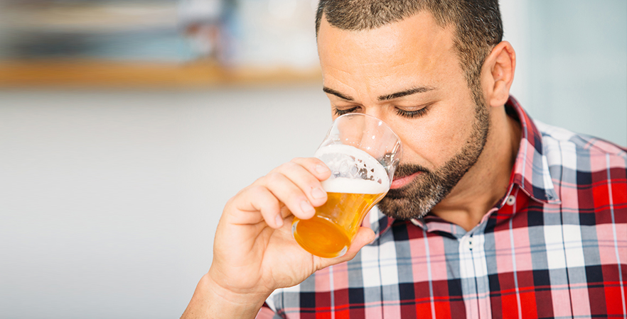 A brewery owner checking if the beer is skunked