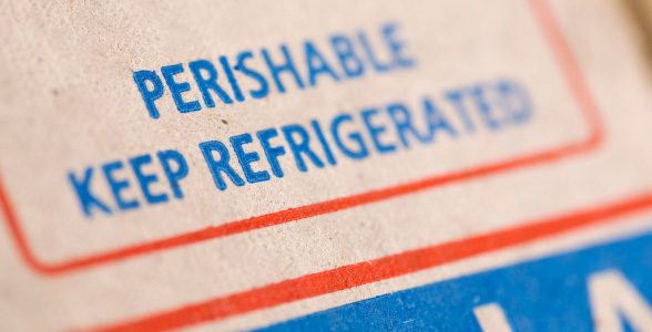 A closeup of a box with the words “perishable, keep refrigerated” written on it.