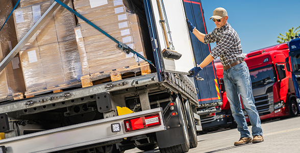 Trucker closing the doors of a truck with full cargo