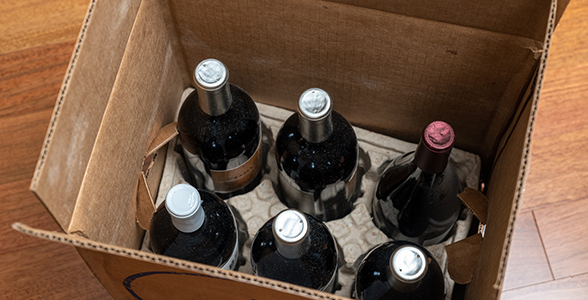 Six bottles of wine inside a box, ready to ship