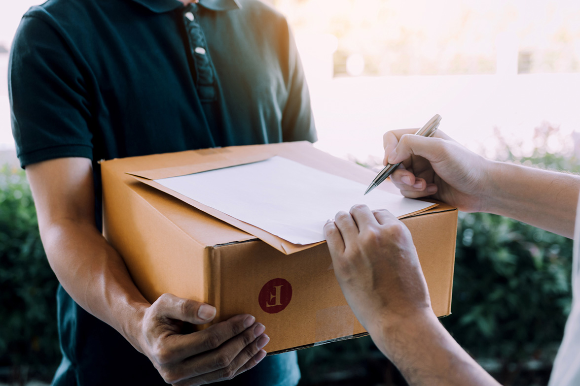  Customer receiving online wine order and signing for it