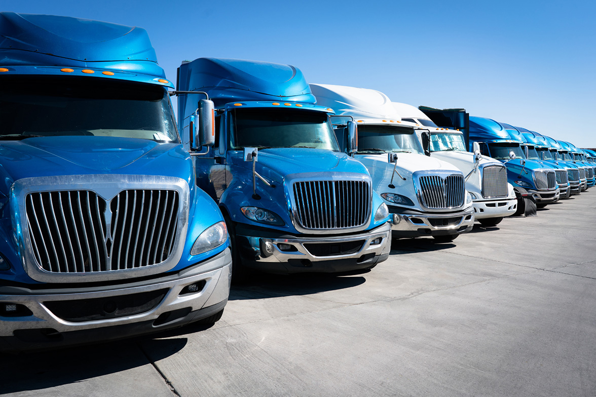 Freight trucks lined up at a trade show yard