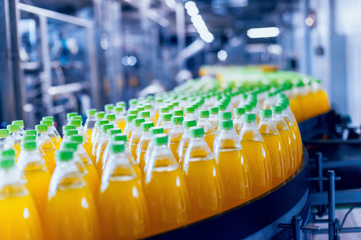 A conveyor with bottles of beverages in production for a drinks business