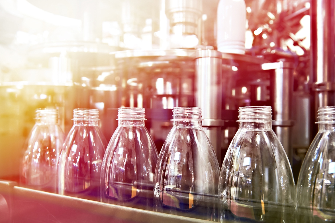 Beverage bottles on an assembly line.