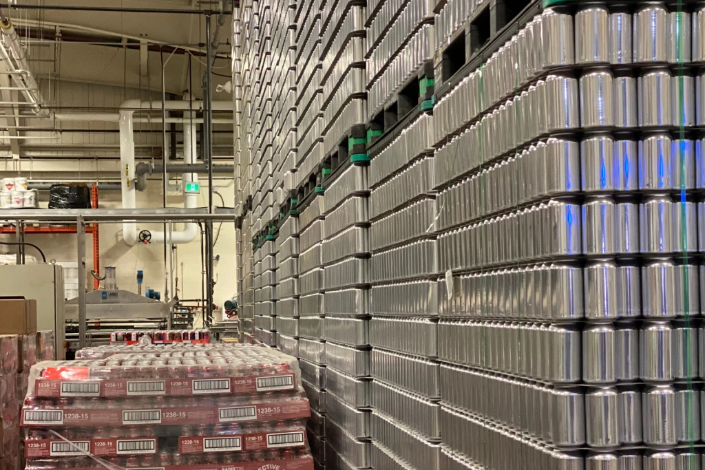 a warehouse depicting pallets of cans