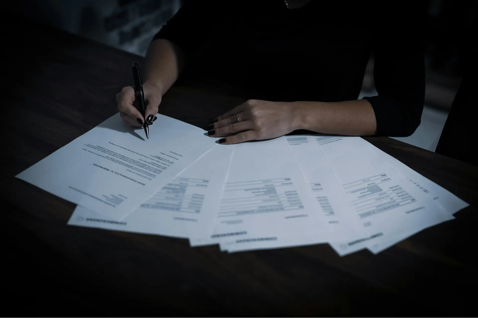 a woman with paperwork laid out in front of her