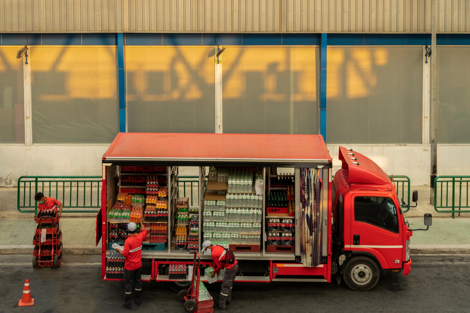 Workers unloading beverages from a temperature-controlled truck