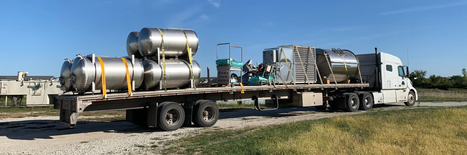 a truck transporting large canisters