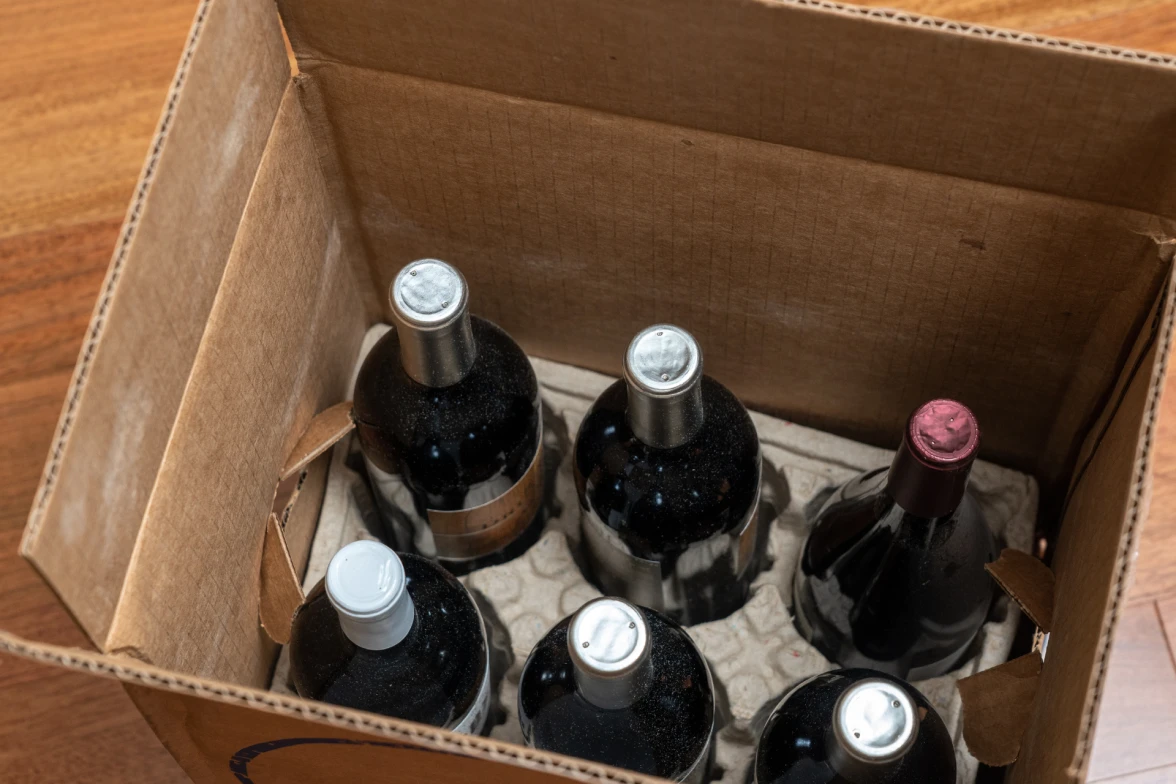 A case of six wine bottles.