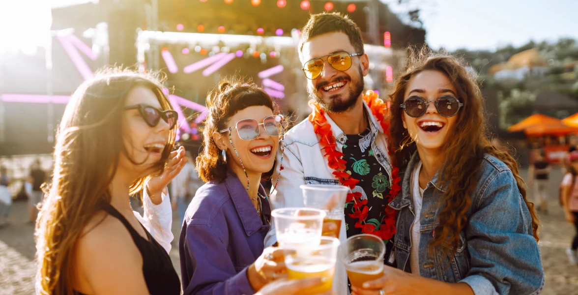 A group of friends drinking and having fun at a beer festival together.